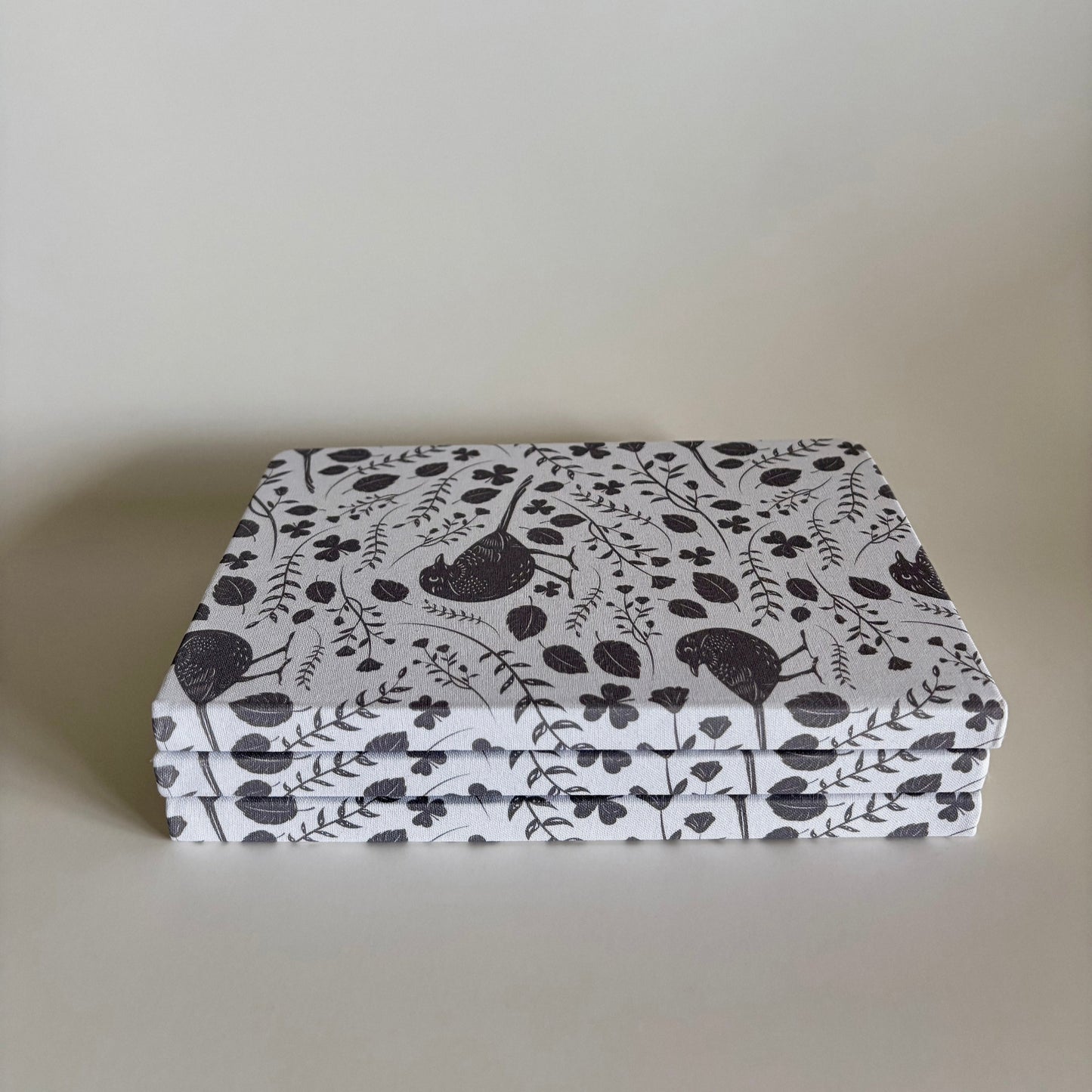 Stack of blackbird notebooks made from 100% recycled, tree-free materials including repurposed fabric, paper waste, soft cotton, and bamboo scraps.