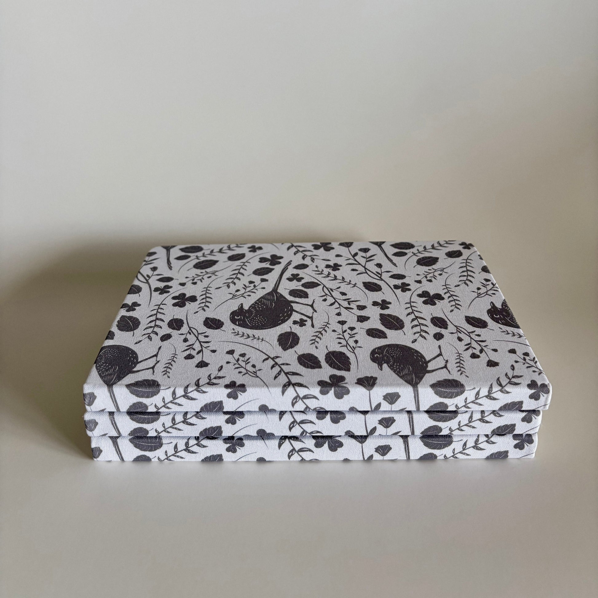 Stack of blackbird notebooks made from  100% recycled, tree-free materials including repurposed fabric, paper waste, soft cotton, and bamboo scraps.