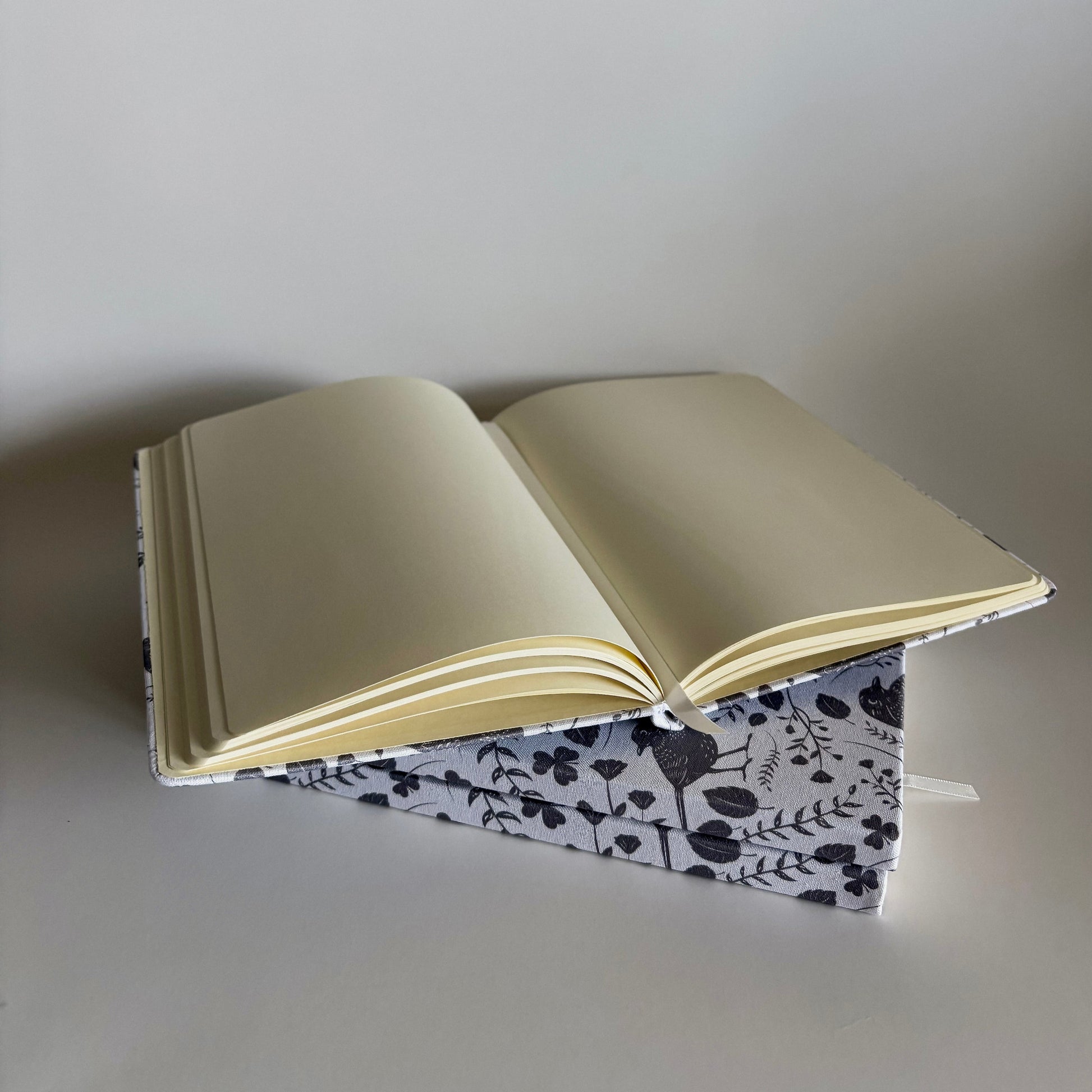 Stack of blackbird notebooks made from  100% recycled, tree-free materials including repurposed fabric, paper waste, soft cotton, and bamboo scraps.