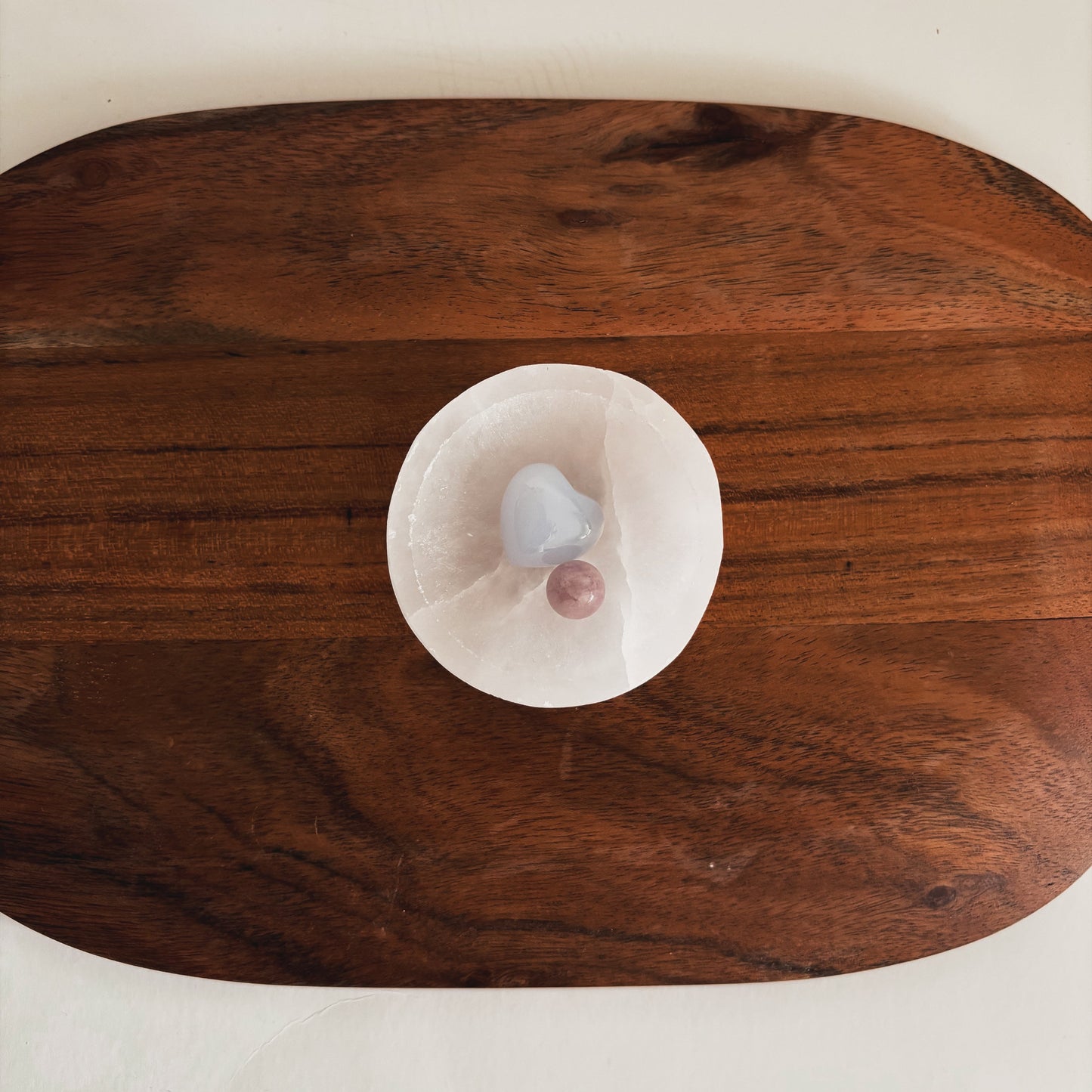 Blue Chalcedony and Kunzite crystals in a selenite dish