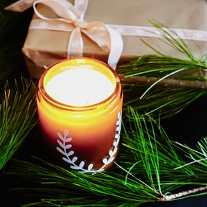 Victorian Christmas soy candle, surrounded by fir branches, berries, and pine cones, Blackett & Co. soy candles handmade in Halifax, Nova Scotia