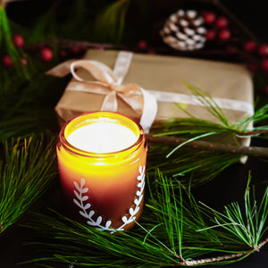 Victorian Christmas soy candle, surrounded by fir branches, berries, and pine cones, Blackett & Co. soy candles handmade in Halifax, Nova Scotia