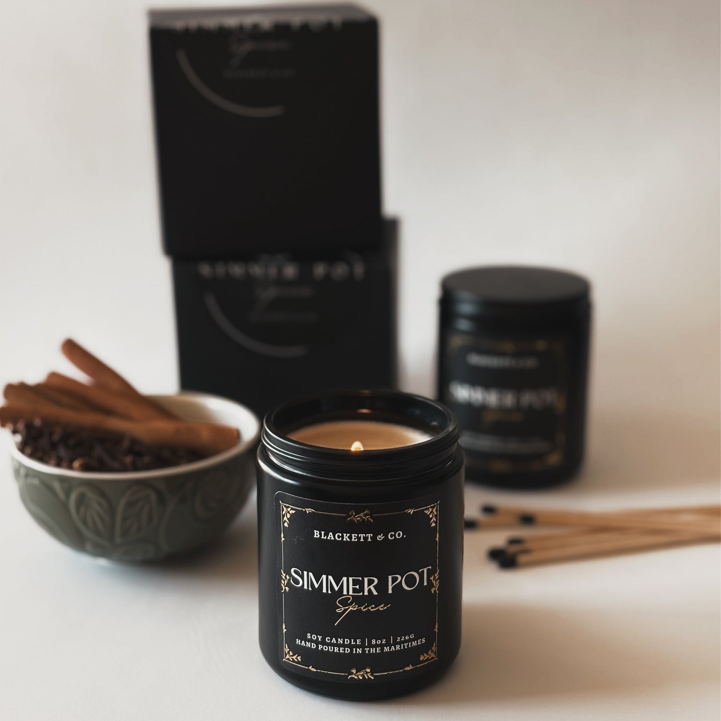 Simmer Pot Spice scented natural soy candle made in Nova Scotia with cinnamon sticks and cloves against a light background