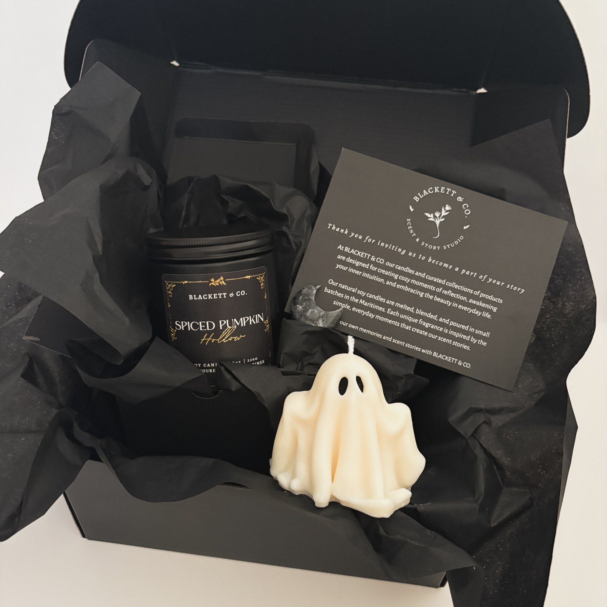 Spiced Pumpkin Hollow scented natural soy candle, unscented ghost-shaped soy candle, and Larvikite moon-shape stone