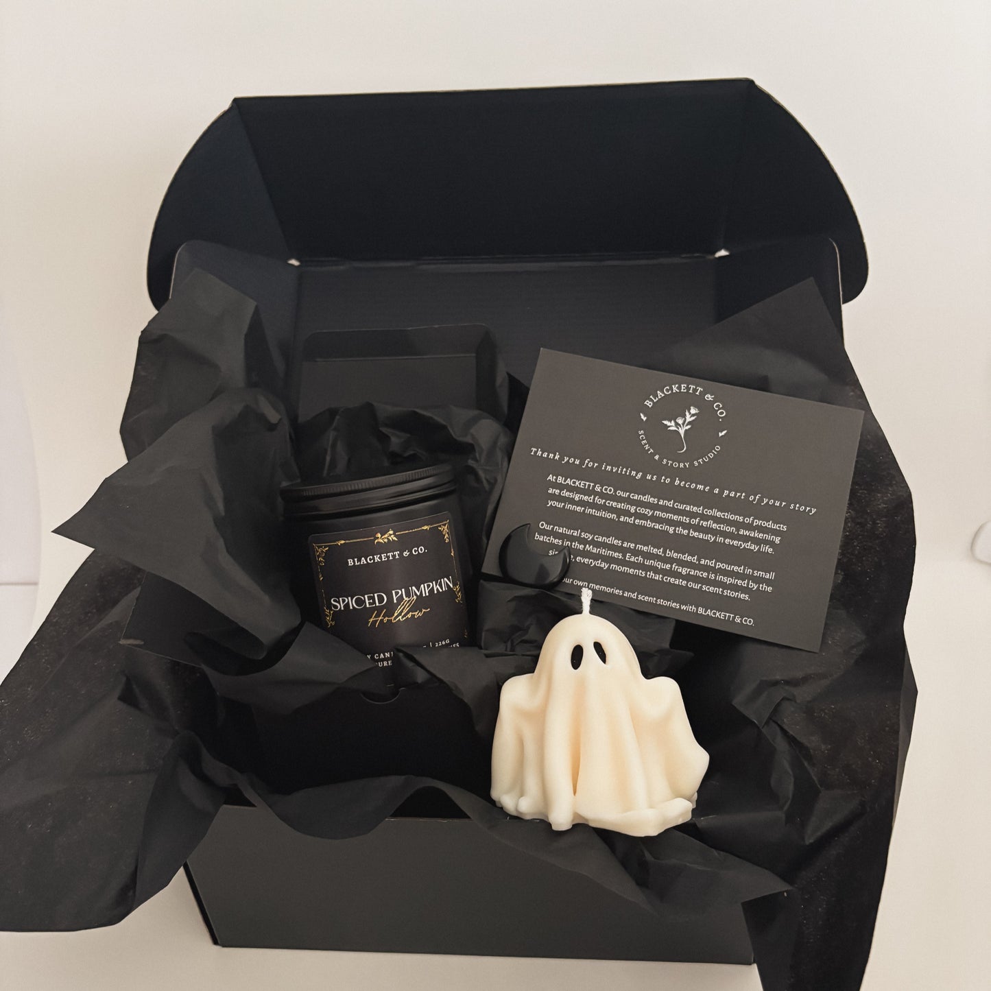 Spiced Pumpkin Hollow scented natural soy candle, unscented ghost-shaped soy candle, and Obsidian stone
