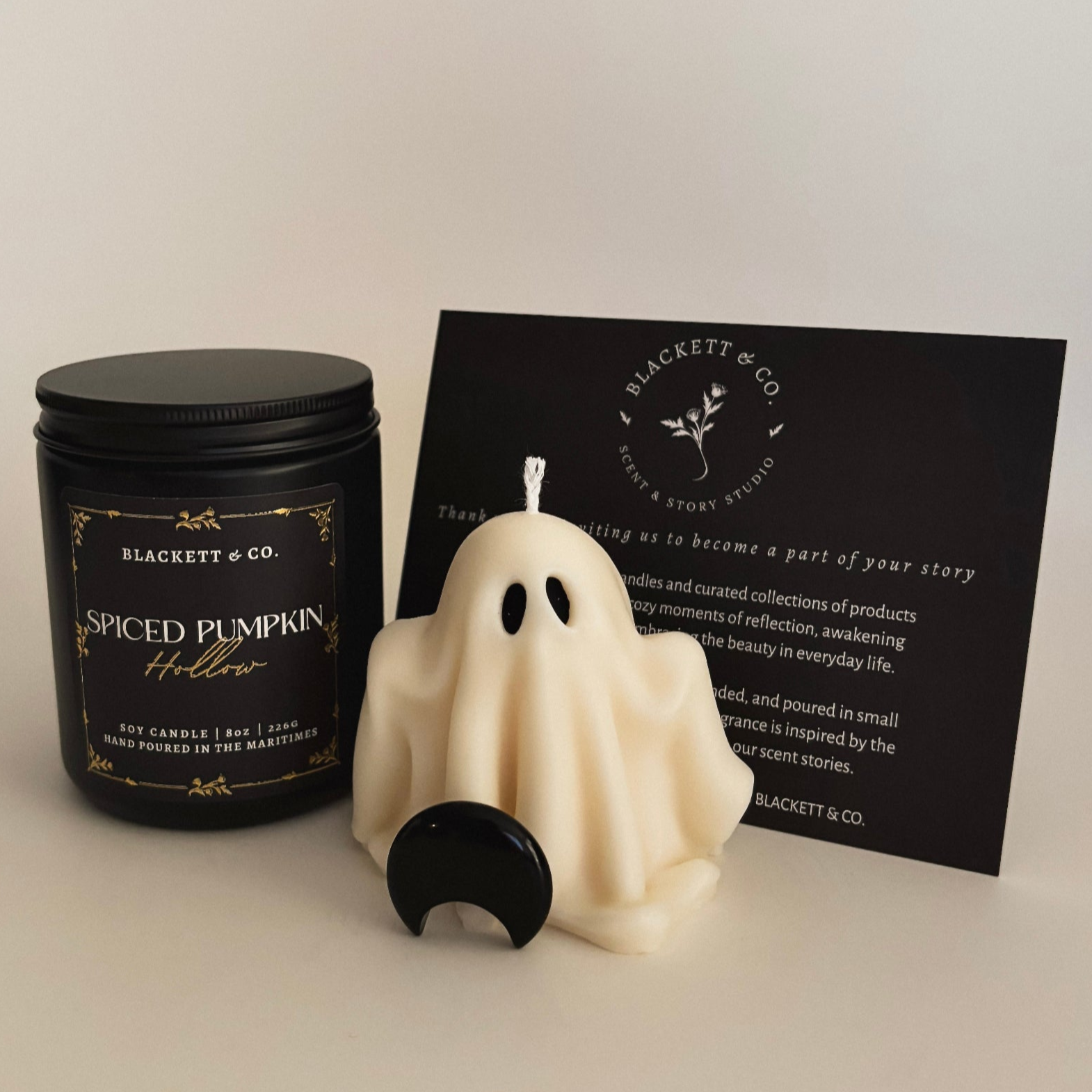 Spiced Pumpkin Hollow scented natural soy candle, unscented ghost-shaped soy candle, and Obsidian stone.