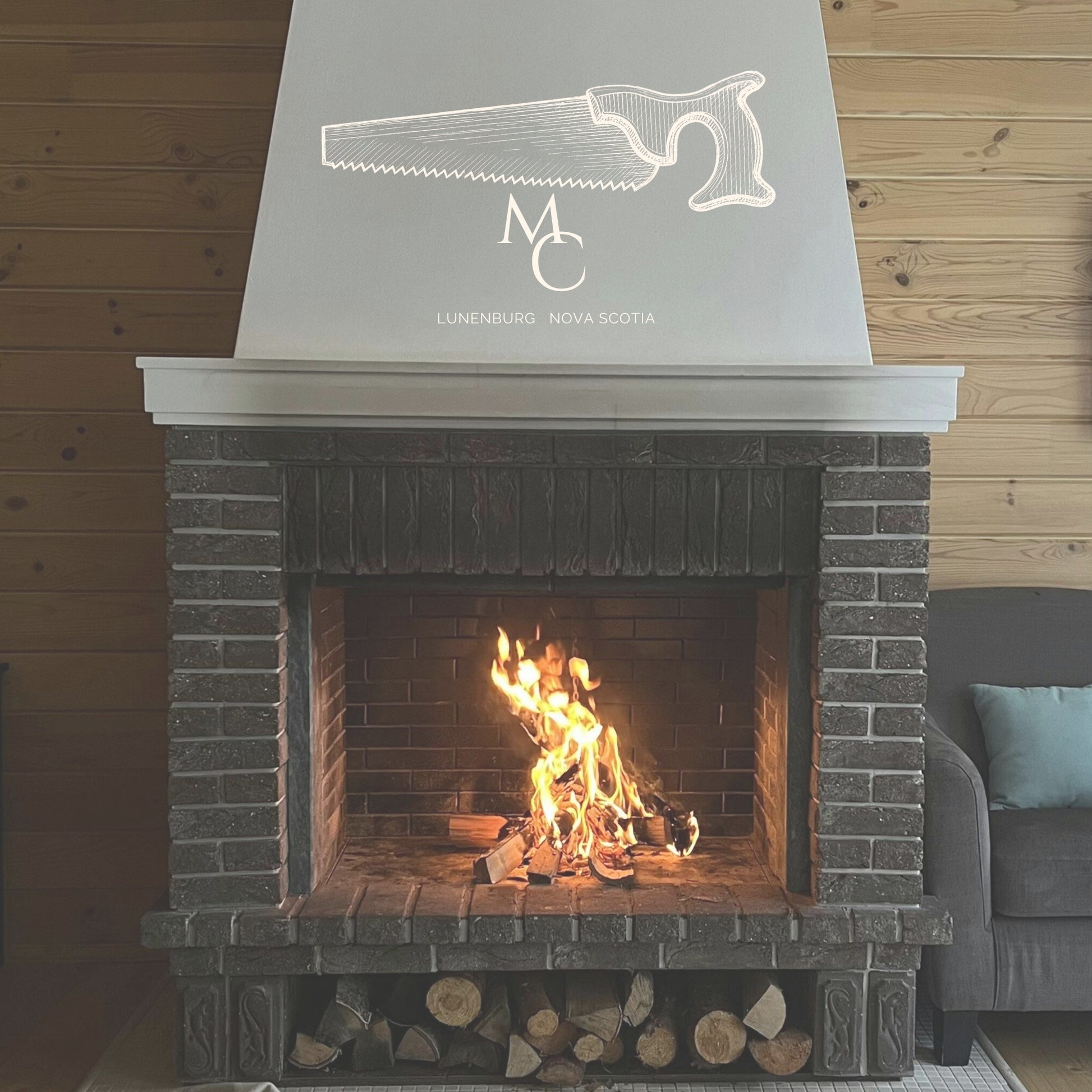 A brick fireplace with a white decorative mantel and a large white logo featuring a line drawing of a saw and text.
