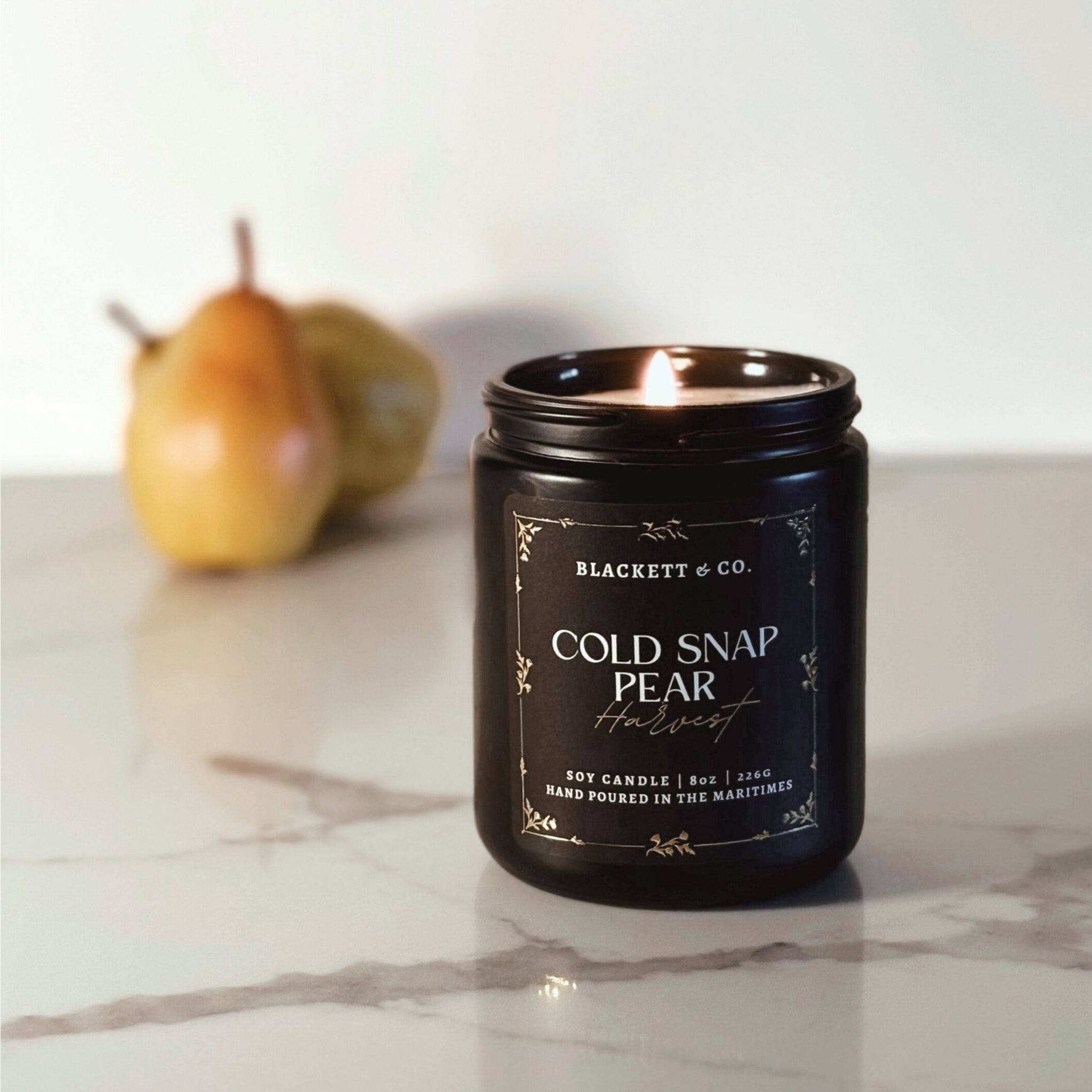 Cold Snap Pear Harvest scented natural soy candle handmade Blackett & Co. on a marble surface.