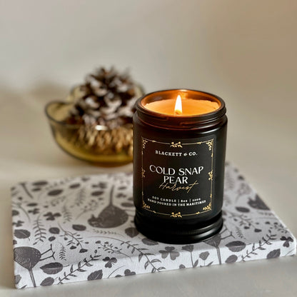 Cold Snap Pear Harvest scented natural soy candle handcrafted by Blackett & Co. and black bird upcycled notebook.