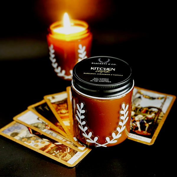 Kitchen Witch soy candle, surrounded by tarot cards, Blackett & Co. soy candles handmade in Halifax, Nova Scotia