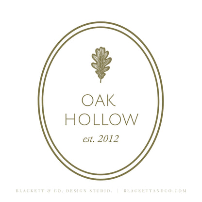 Oak & Hare theme logo on a white background featuring an oval border and oak leaf icon in a muted olive-gold tone.
