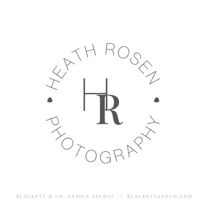 Photography brand logo circular logo design featuring initials in the centre of arched text above and below in thin uppercase text. Small decorative dots flank the initials.