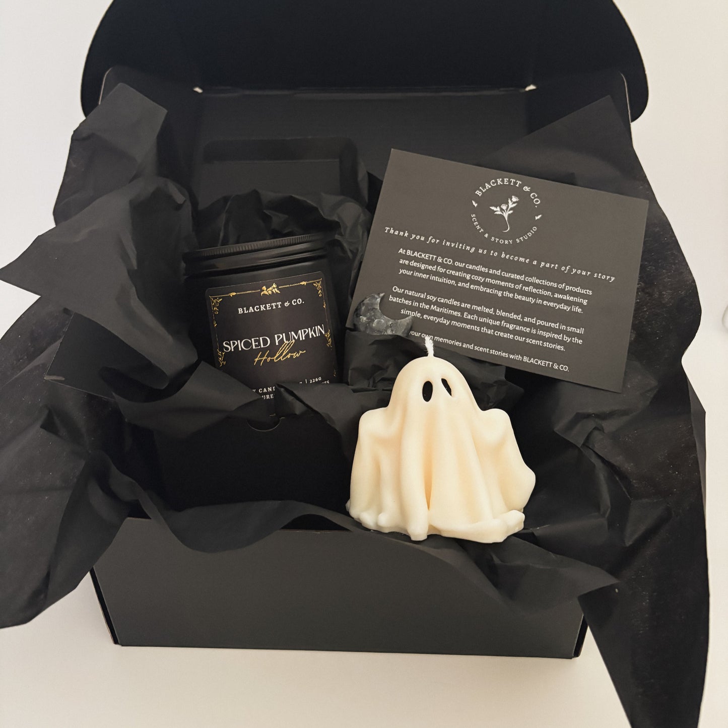 Spiced Pumpkin Hollow scented natural soy candle, unscented ghost-shaped candle, and Larvikite moon-shape stone