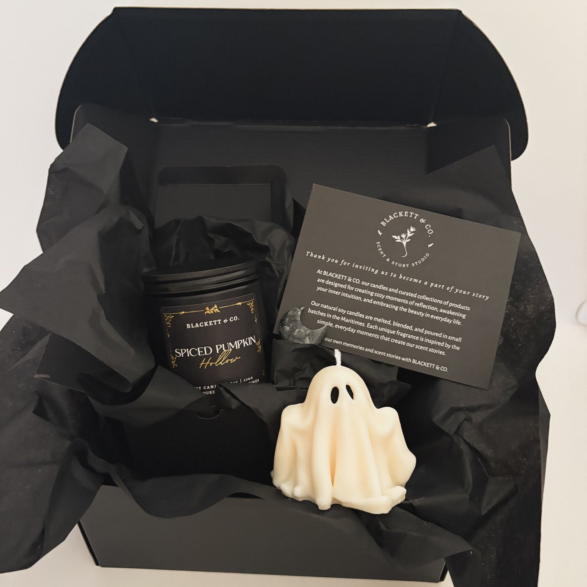 Spiced Pumpkin Hollow scented natural soy candle, unscented ghost-shaped candle, and Larvikite moon-shape stone