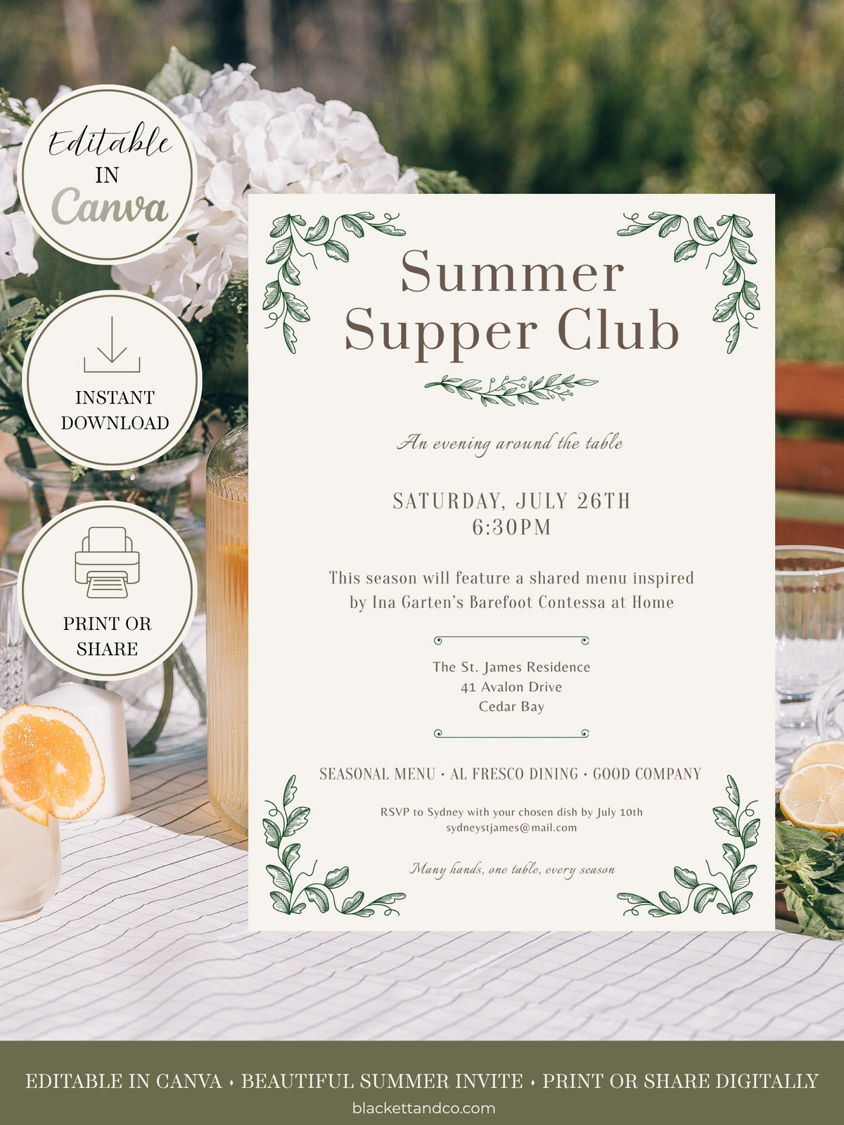 Editable invitation card, featuring a cream background with green leafy borders and elegant typography. The card is displayed on a rustic white-washed wooden table alongside white flowers, a glass of water, and citrus slices.