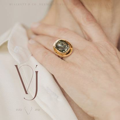 Vela brand logo design by Blackett & Co. on a jewellery product photo featuring a green and gold ring.
